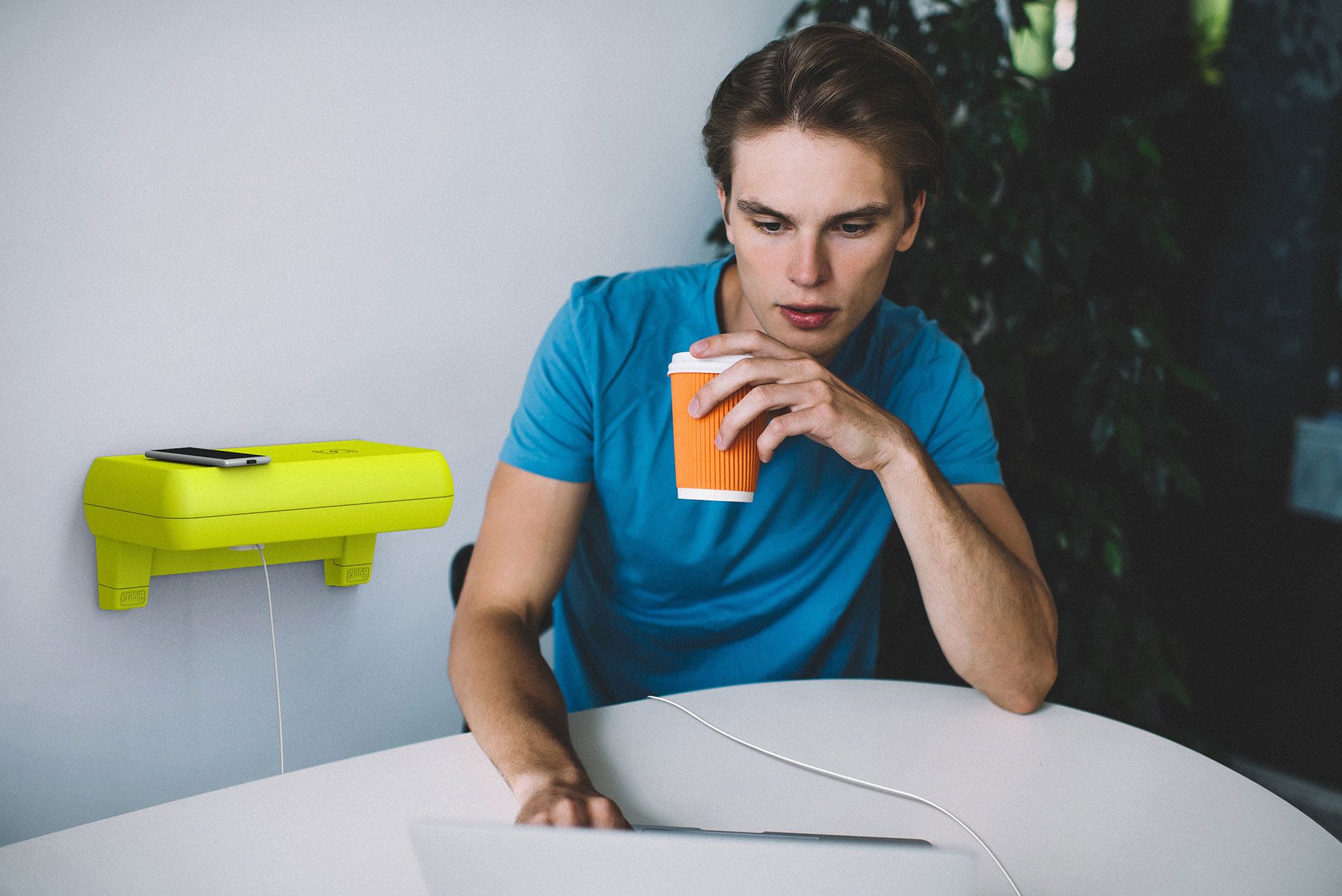 Crable shelving unit charging man's laptop as he works