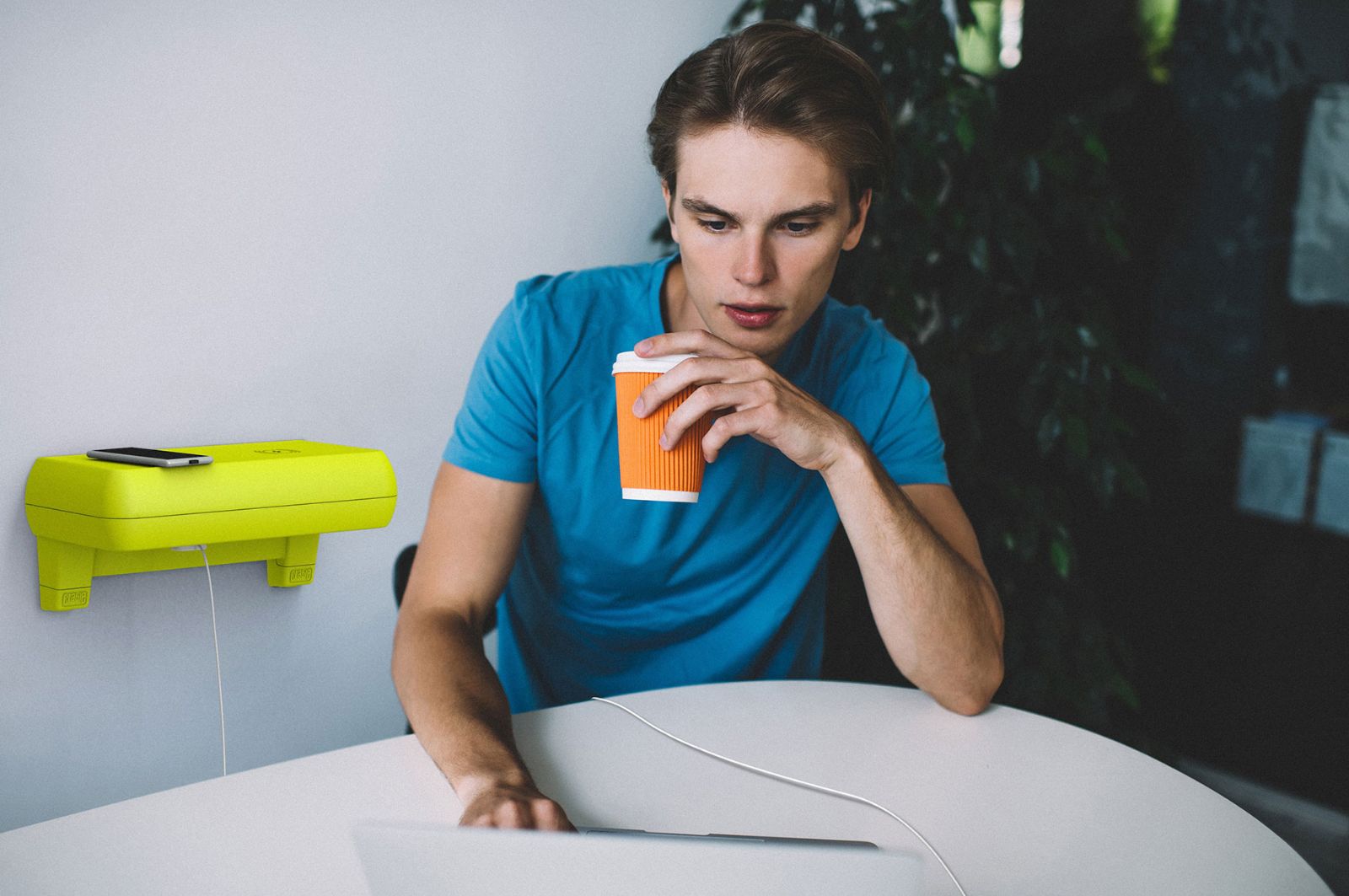 Office worker using Crable to charge their laptop